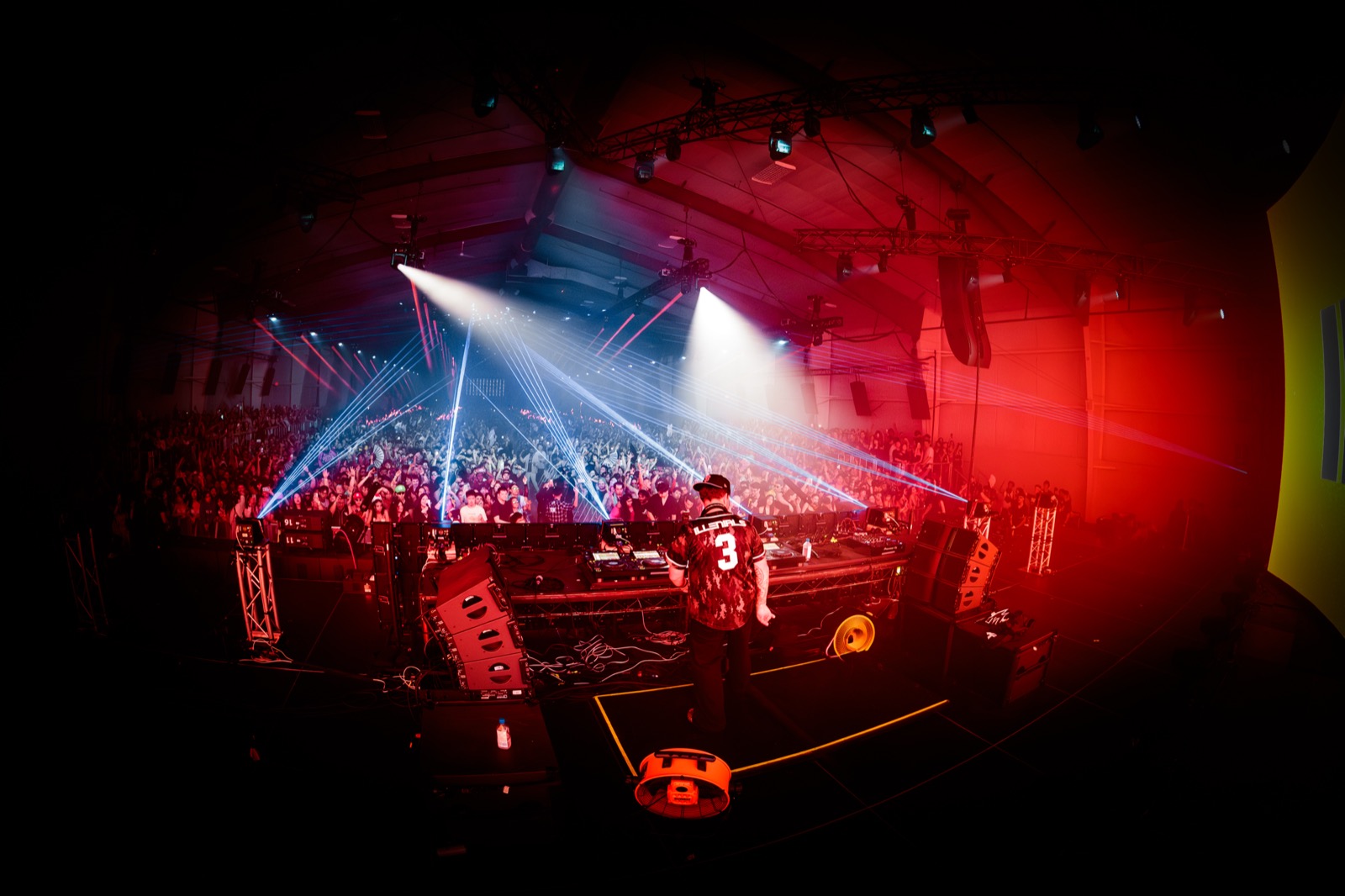 Lost in Dreams — view from behind the DJ booth, red and blue lasers over the crowd