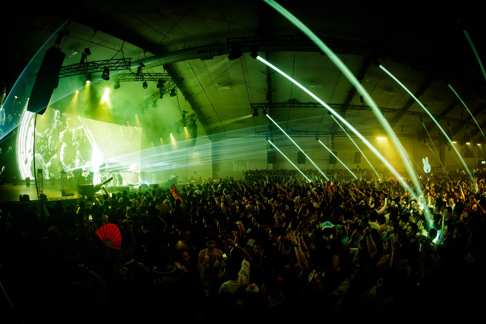 Lost in Dreams — wide shot of a packed floor under green and yellow lasers