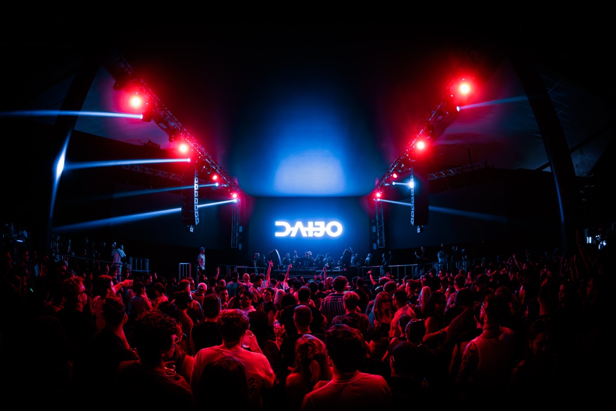Harbour Event Centre — red and blue wash across the truss and LED wall above a packed floor